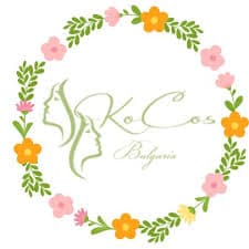KoCos Bulgaria logo featuring two female profiles surrounded by a colorful floral and leafy wreath.